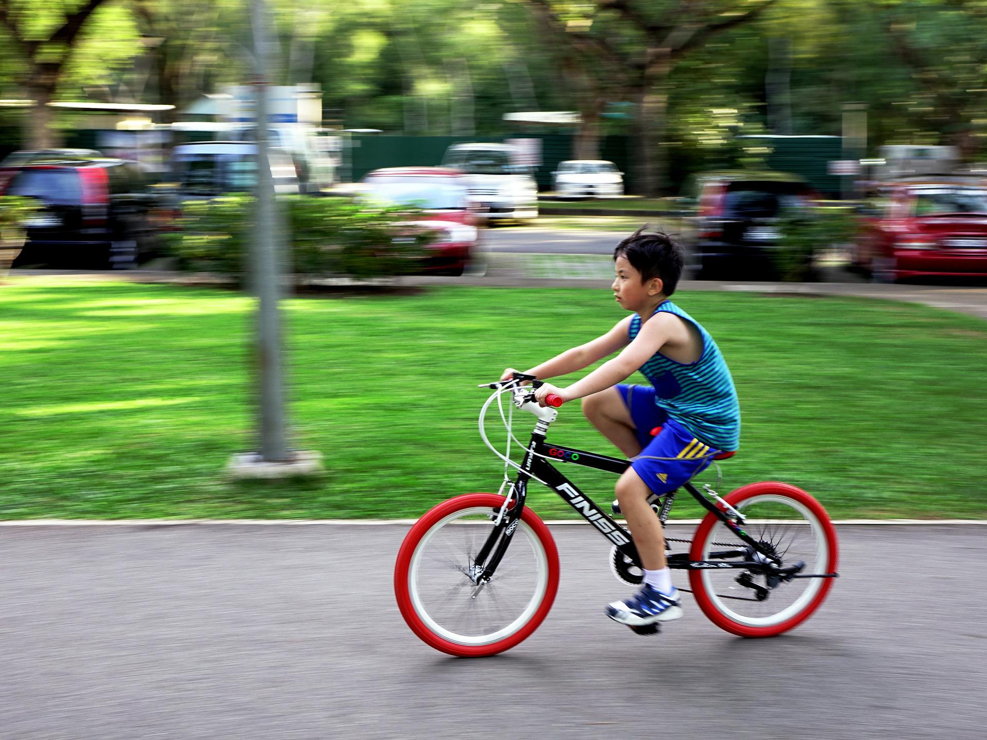 A little boy riding his bike