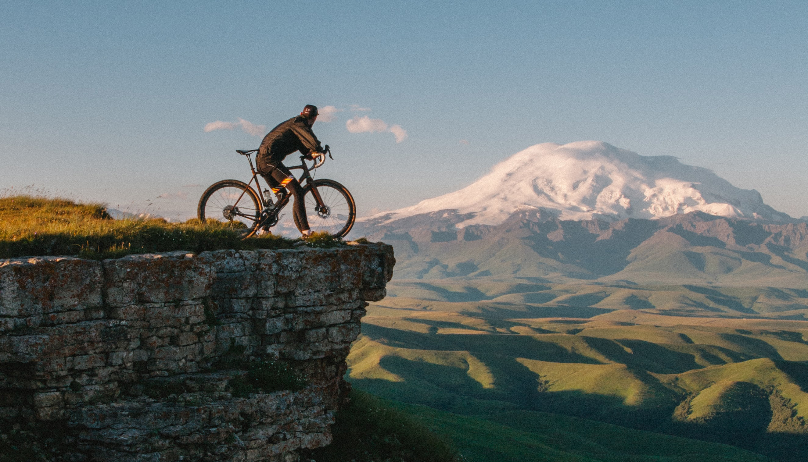 a man on his look out at a snowcapped mountain